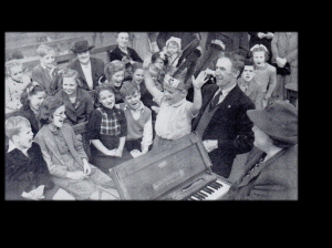 Seth and Bessie lead children to sing songs of the Savior. Note the small folding organ that Bessie is playing. Source: Eva Sykes Campbell, daughter of Seth and Bessie Sykes.